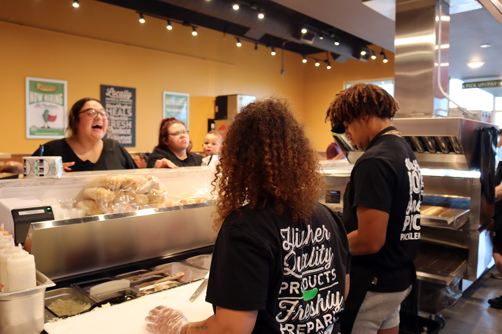 IMG_2093 Customers laughing with Pickleman's employees while standing in line to order their food